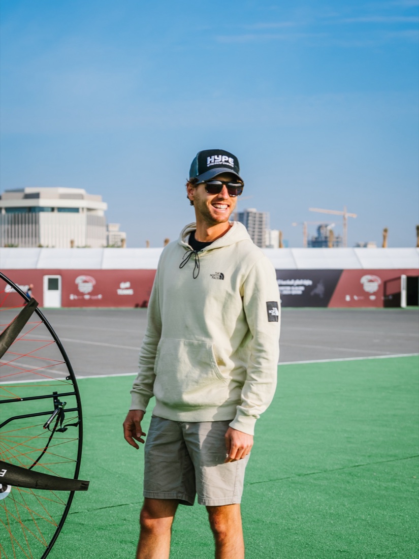Nico Aubert beside his paramotor at a championship venue